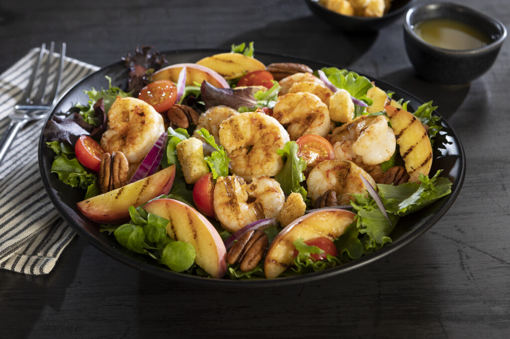 Warm grilled peach and Argentinian shrimp salad